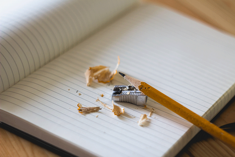 Pencil & sharpener on notebook