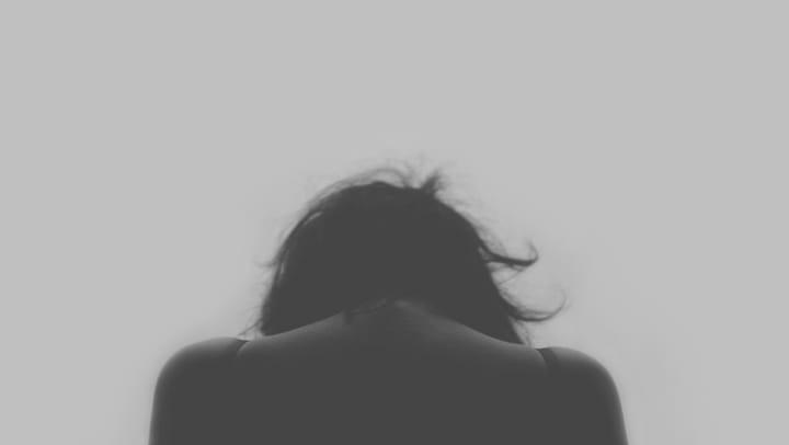A person from the back, head down